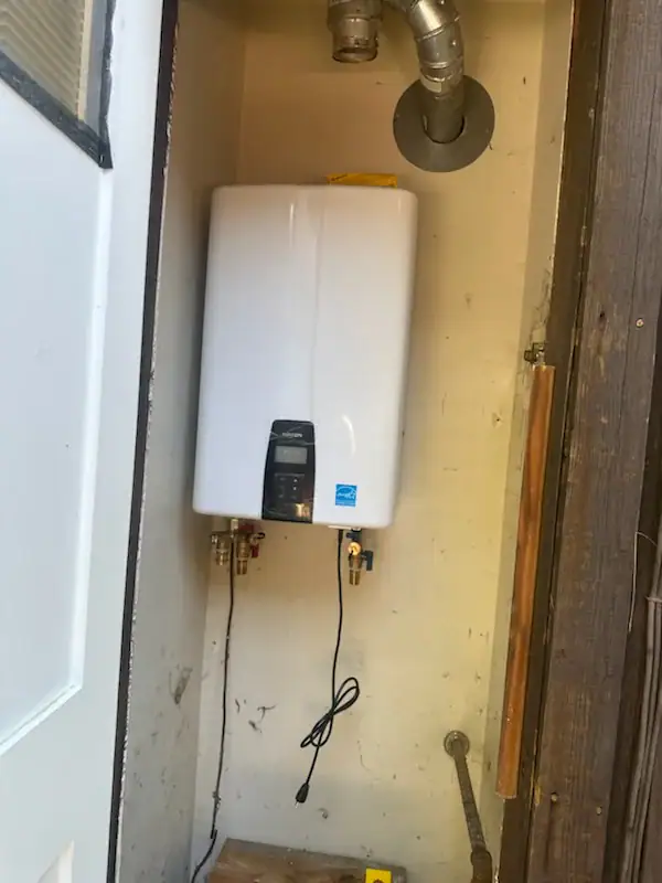 Interior view of a residential water heater closet in El Dorado County, CA with gas water heater and copper piping